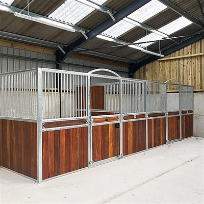 What factors are usually considered in the design and construction of stables